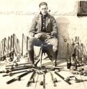 Police officer posing with confiscated opium pipes, San Francisco, 1924.